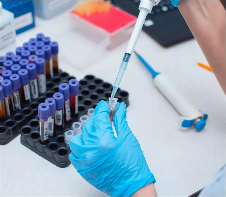 pharmacist pulling medicine up through a syringe