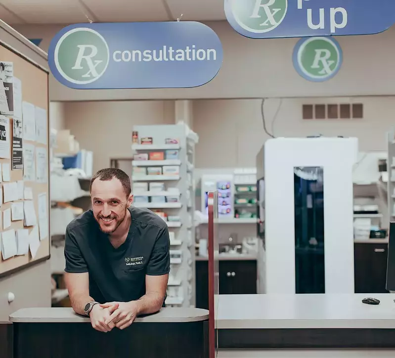 pharmacist at Washington Health & Drug standing at counter