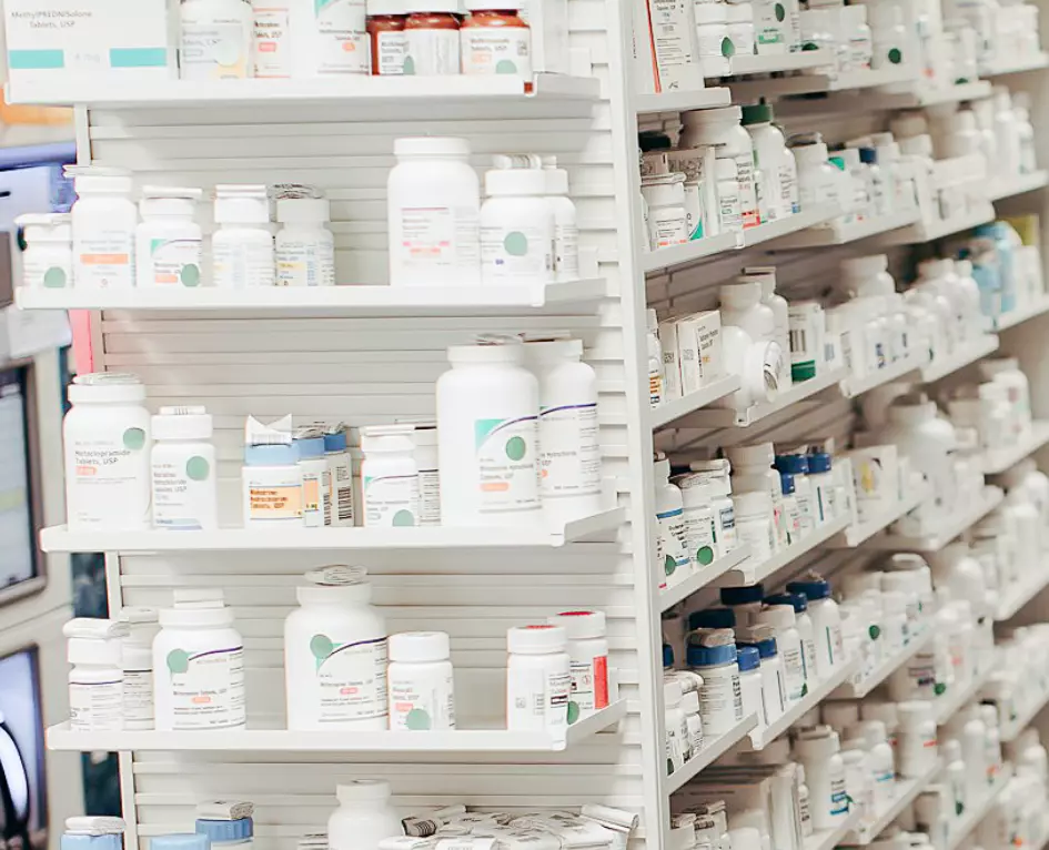 variety of pharmacy medications sitting on a shelf 