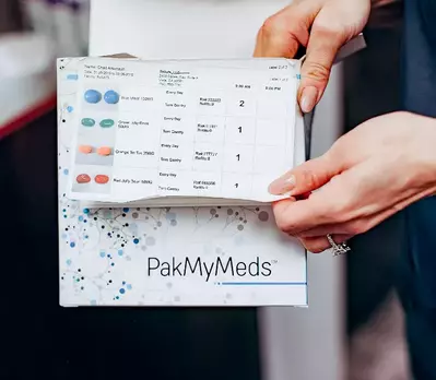 pharmacist flipping through a medication catalog
