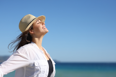 smiling woman in sun hat outdoors