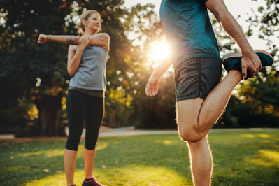 man and woman stretching outdoors