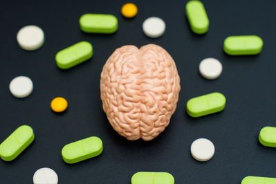 brain model surrounded by supplements