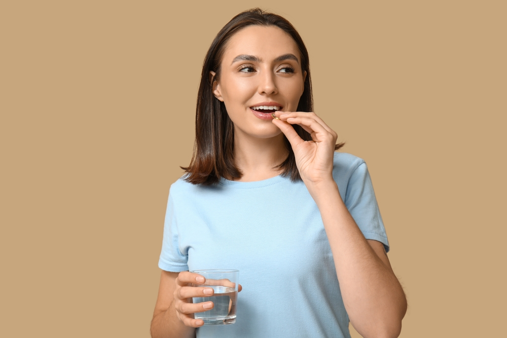 woman taking supplement